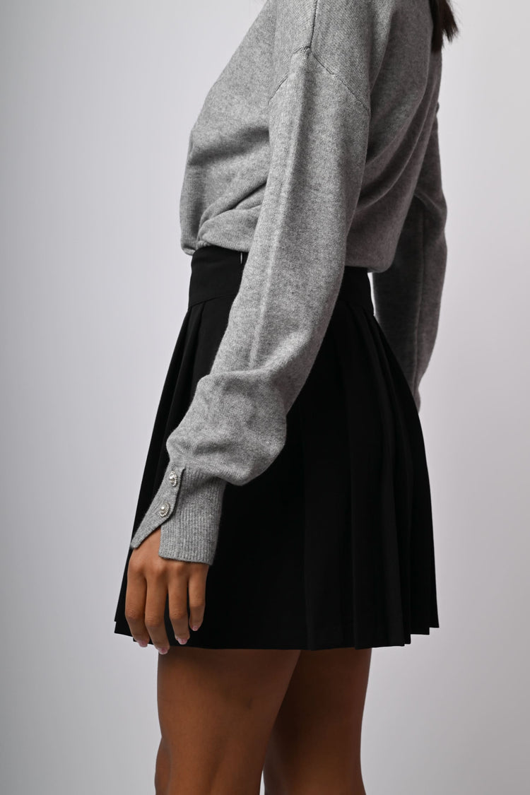 Minigonna a pieghe con bottoni