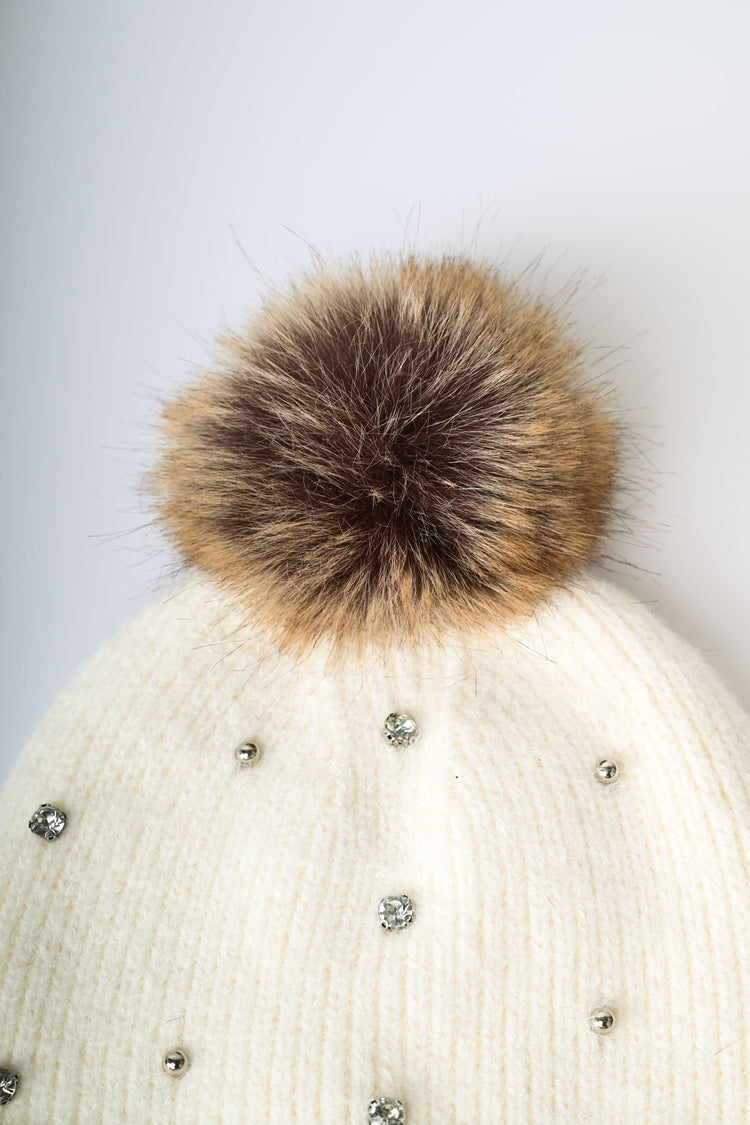 Berretto con pompon e strass