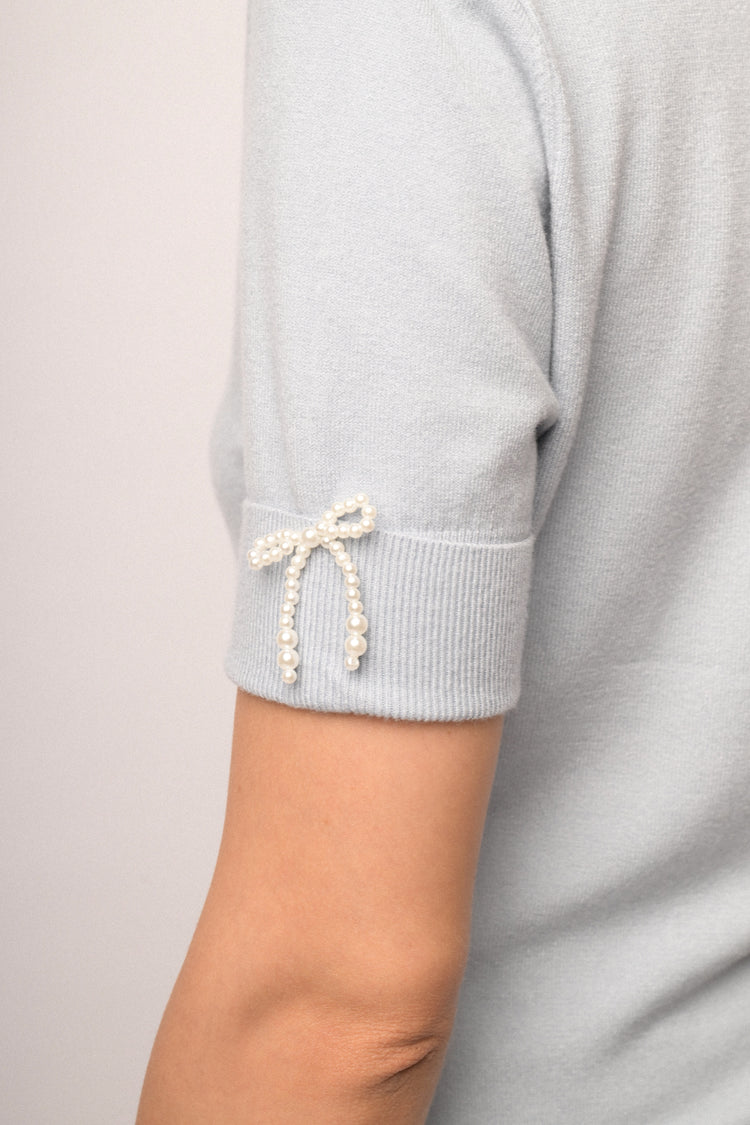 Maglia con fiocco perline manica